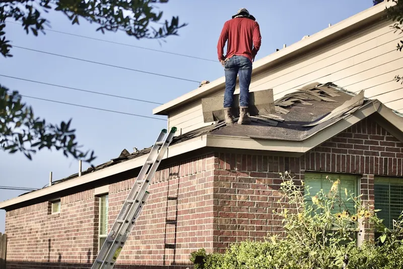Professional roofer working on a residential roof in Prospertown